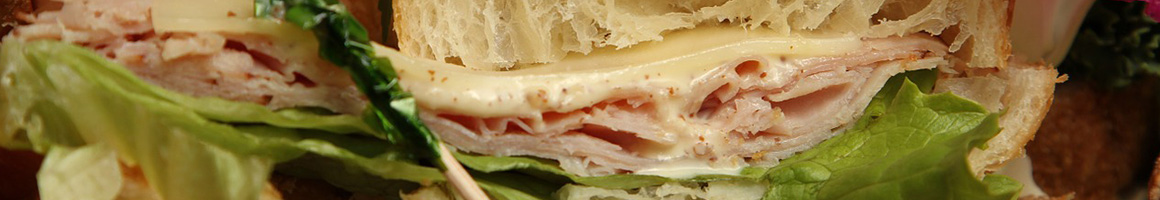 Eating Deli Sandwich at Your Butcher Frank restaurant in Longmont, CO.